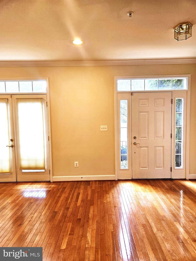 foyer featuring crown molding and hardwood / wood-style floors