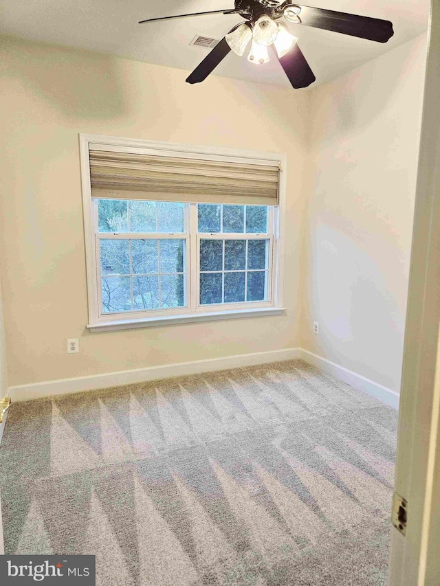 unfurnished room featuring carpet, a wealth of natural light, and ceiling fan