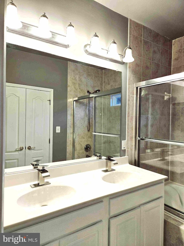 bathroom featuring walk in shower and vanity