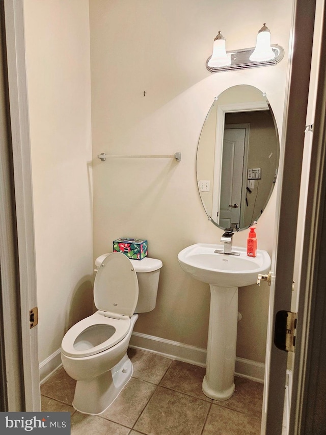 bathroom with tile patterned floors and toilet