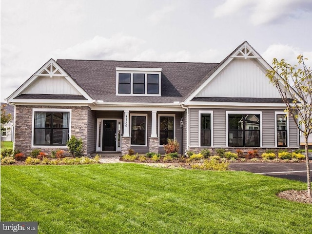 craftsman-style home with a front yard