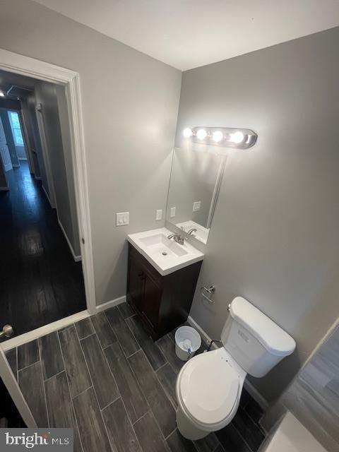 bathroom featuring toilet and vanity