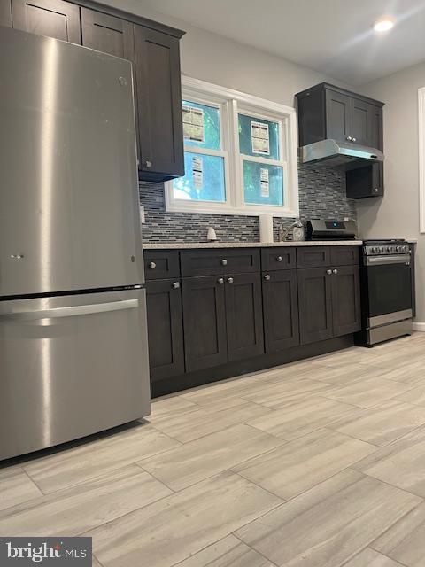 kitchen with decorative backsplash and stainless steel appliances