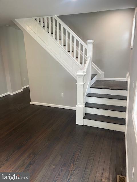 staircase with wood-type flooring