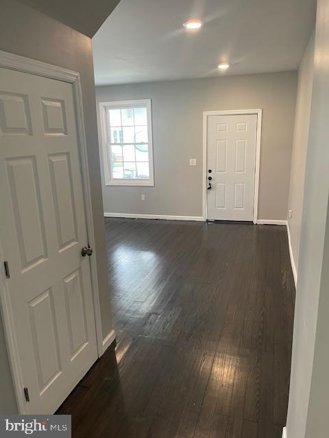 entryway with dark hardwood / wood-style floors