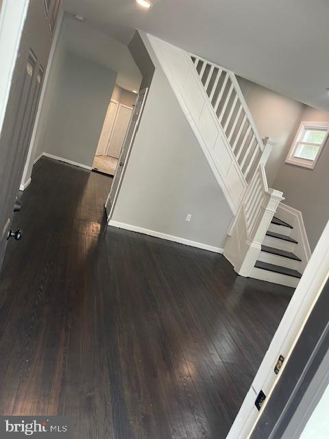 stairs featuring wood-type flooring