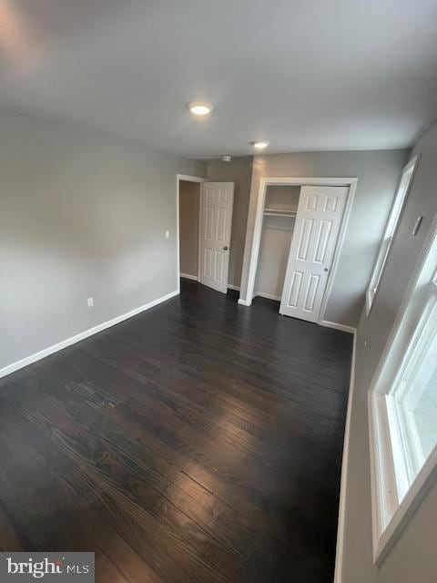 unfurnished room featuring dark wood-type flooring