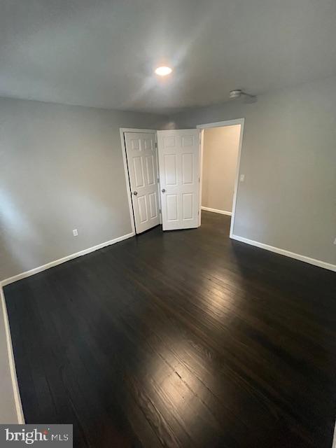 spare room with dark hardwood / wood-style flooring