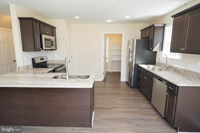 kitchen with dark brown cabinets, sink, and stainless steel appliances