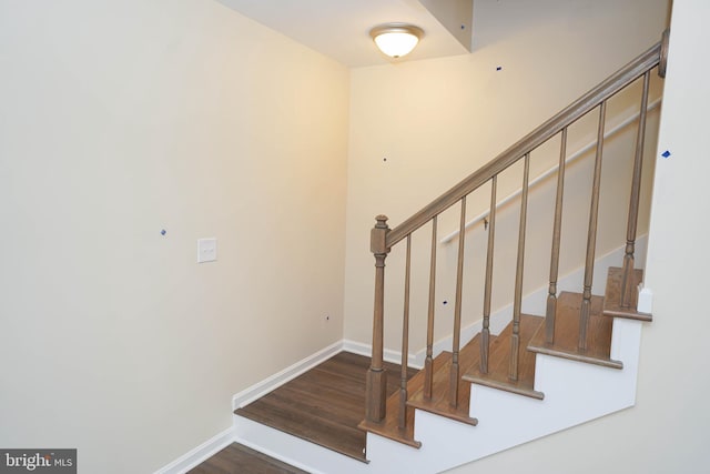 stairs featuring hardwood / wood-style flooring