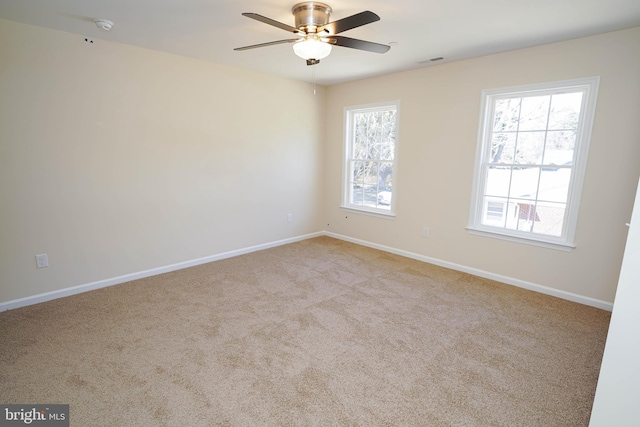 carpeted empty room featuring ceiling fan