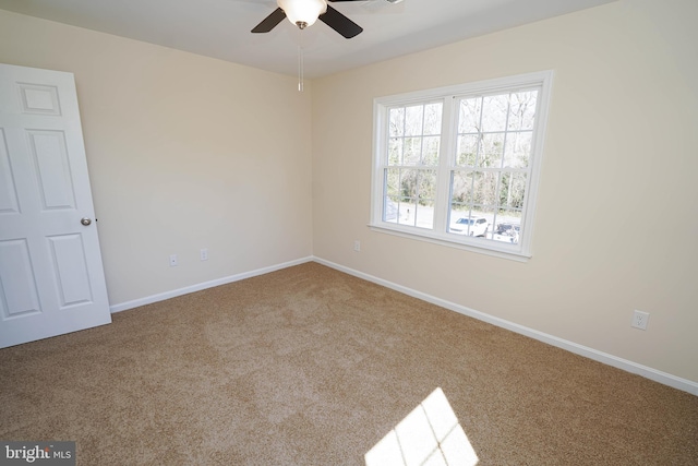 carpeted empty room featuring ceiling fan