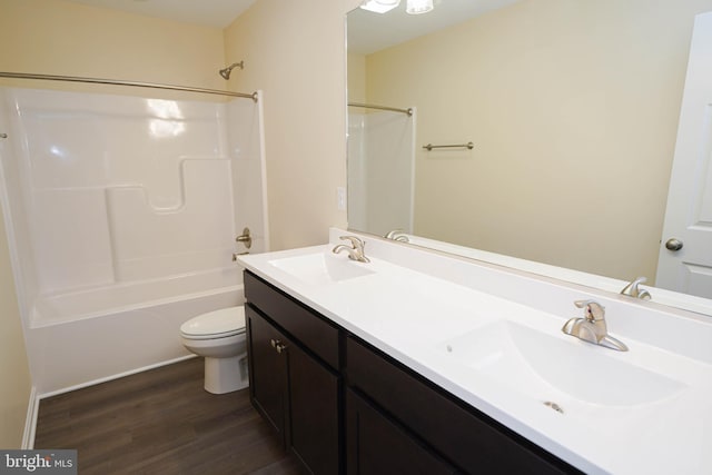 full bathroom with hardwood / wood-style flooring, toilet, vanity, and shower / bathtub combination