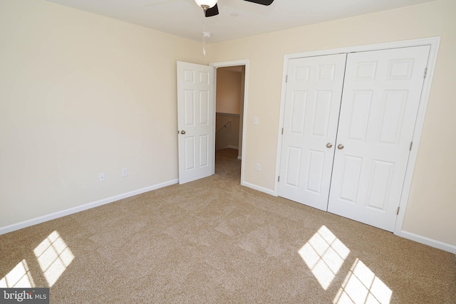 unfurnished bedroom featuring ceiling fan, a closet, and carpet floors