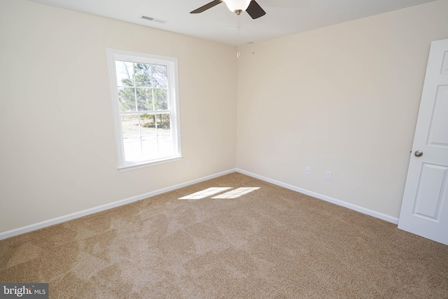 spare room with carpet floors and ceiling fan