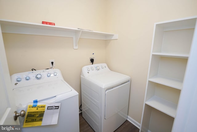 laundry area with dark hardwood / wood-style floors and washing machine and dryer