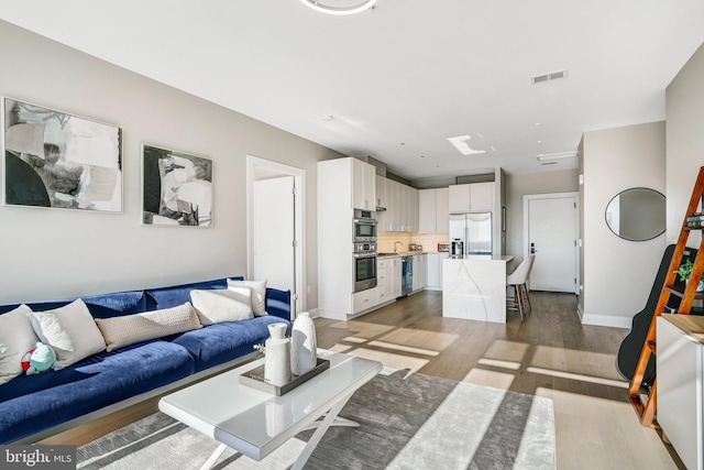 living room with light hardwood / wood-style floors