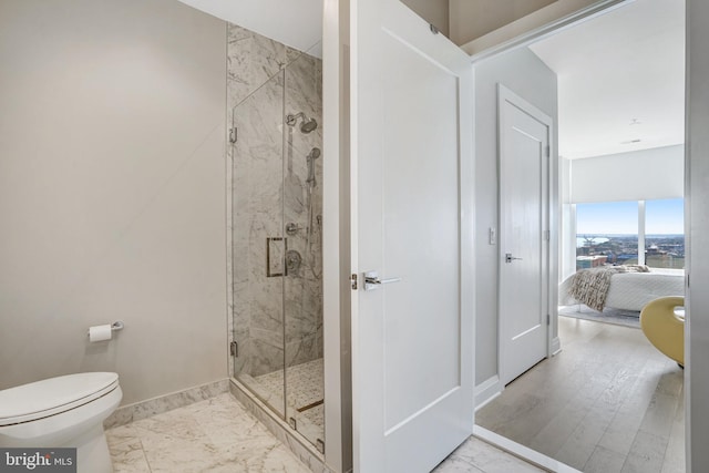 bathroom featuring toilet and an enclosed shower