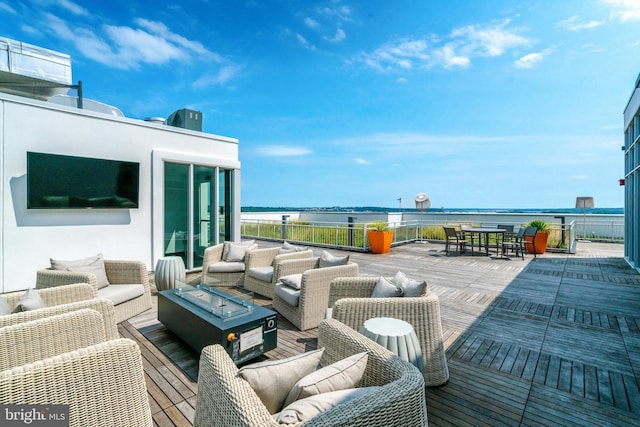 view of patio with an outdoor living space with a fire pit and a deck