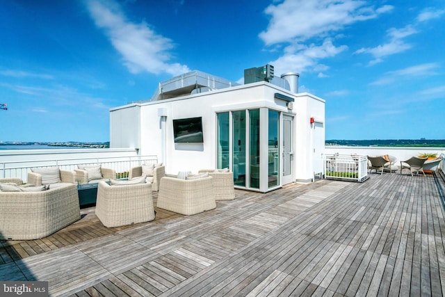 wooden terrace featuring an outdoor hangout area and a water view