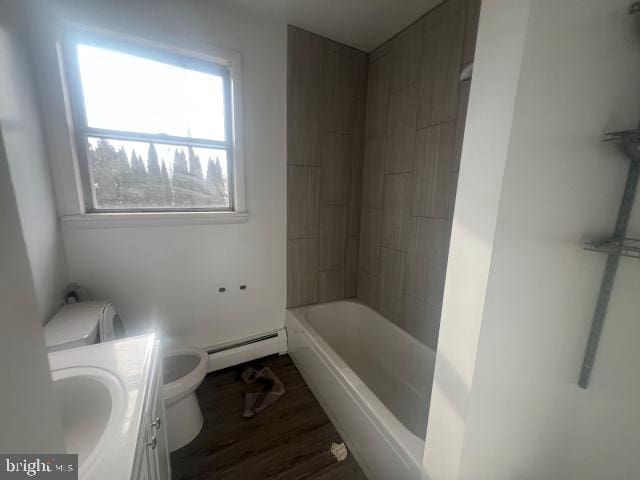 full bathroom featuring wood-type flooring, a baseboard heating unit, vanity, toilet, and shower / bathtub combination