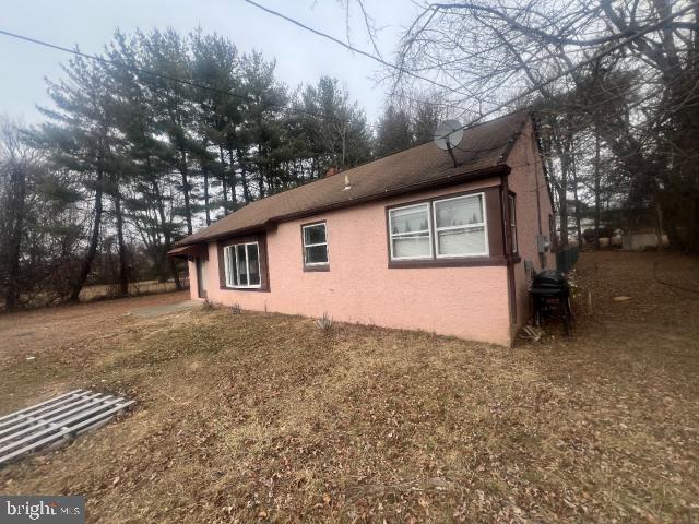 view of side of home with a lawn