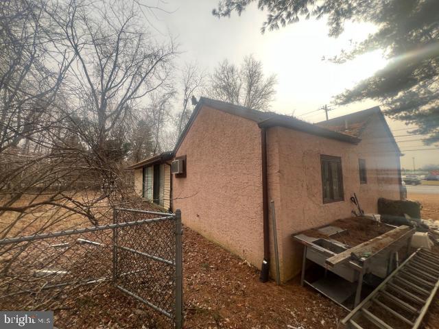 view of side of property with a wall unit AC