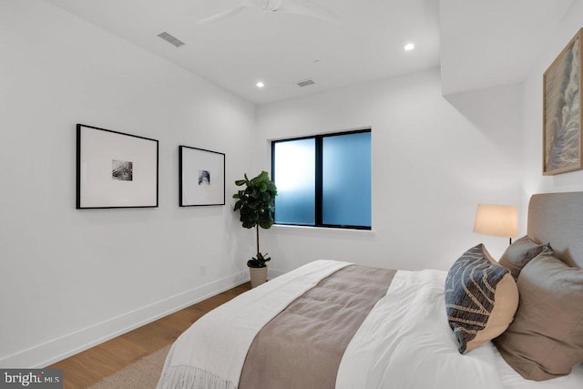 bedroom with wood-type flooring