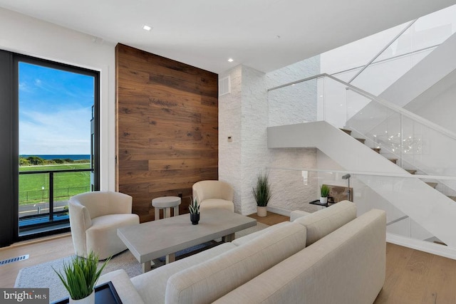 living room featuring wood-type flooring and wooden walls