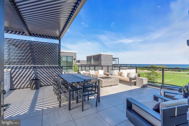 view of patio / terrace with a water view and an outdoor living space with a fire pit