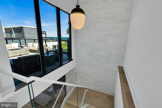 staircase with wood-type flooring and a water view