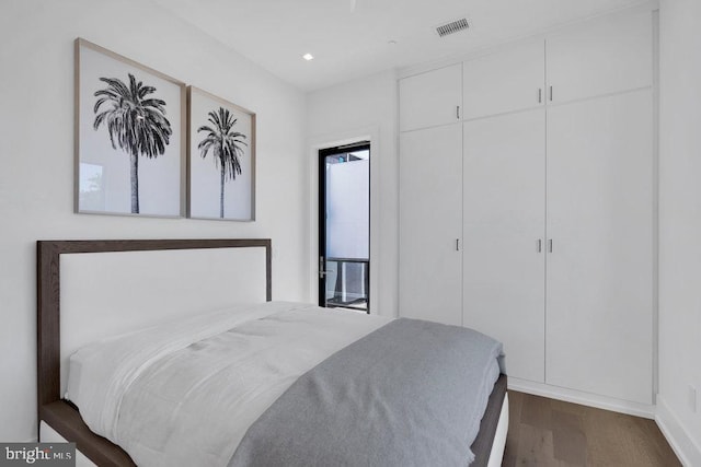 bedroom featuring dark hardwood / wood-style flooring and a closet