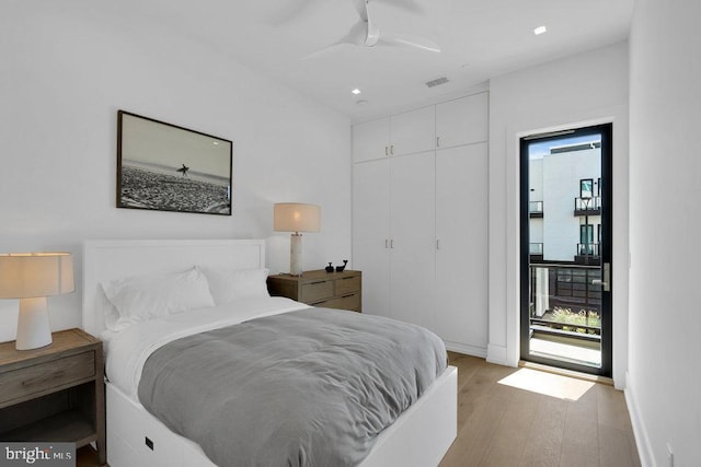 bedroom featuring ceiling fan, light hardwood / wood-style floors, and a closet