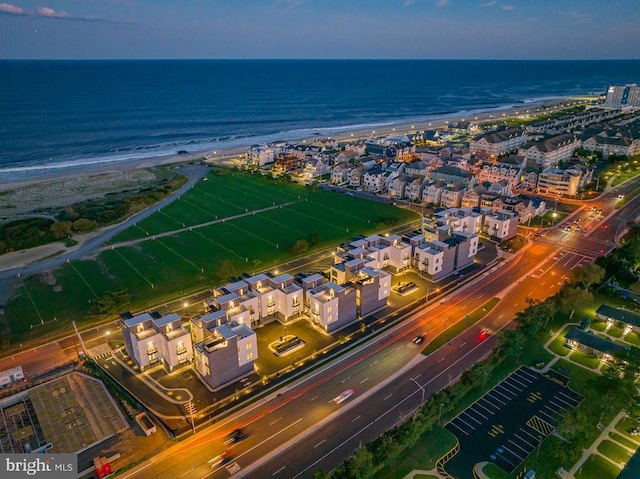 birds eye view of property featuring a water view and a view of the beach