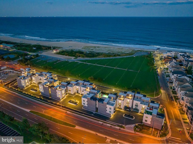 birds eye view of property with a beach view and a water view