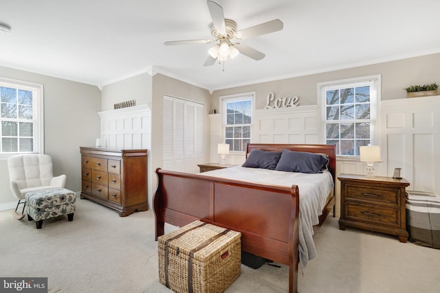 bedroom with multiple windows, crown molding, a closet, and ceiling fan