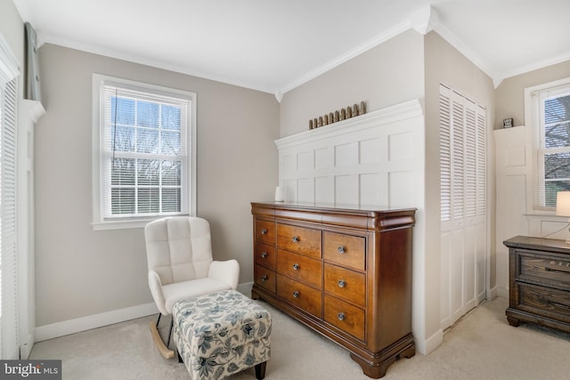 sitting room featuring crown molding and light colored carpet