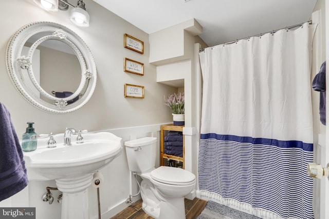 bathroom with toilet and hardwood / wood-style floors