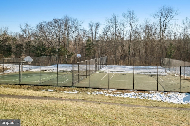 view of sport court featuring a yard and basketball court