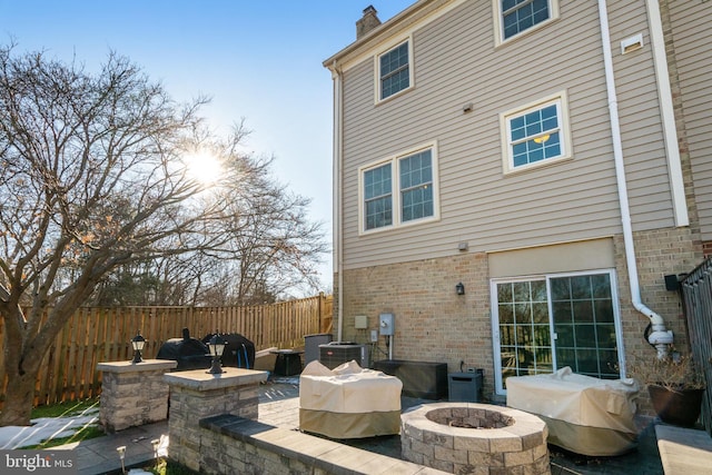 view of patio / terrace featuring a grill, central AC unit, and a fire pit