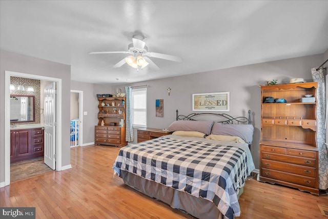 bedroom featuring ceiling fan, light hardwood / wood-style floors, and connected bathroom