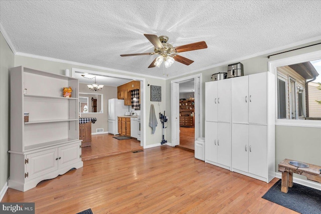 interior space with light hardwood / wood-style floors, crown molding, and ceiling fan with notable chandelier