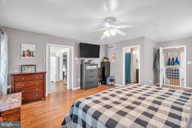 bedroom featuring light wood-type flooring, ensuite bath, and ceiling fan