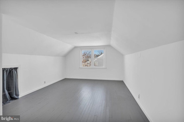 bonus room featuring dark wood-type flooring and lofted ceiling