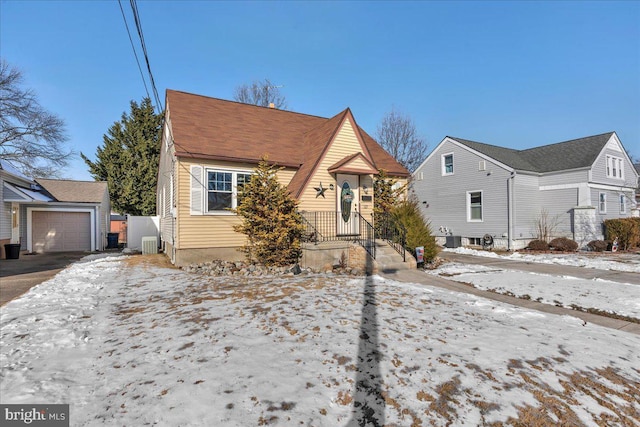 bungalow with a garage, central AC, and an outbuilding