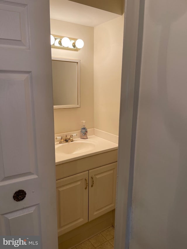 bathroom featuring tile patterned flooring and vanity