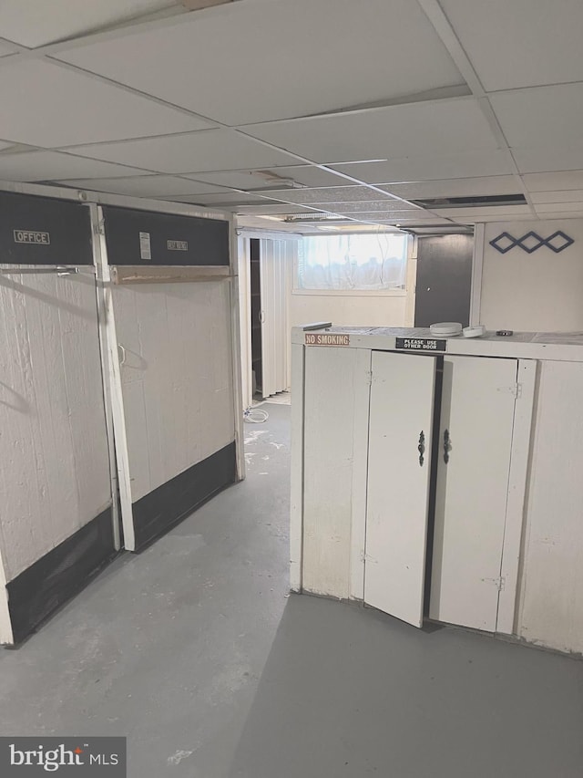 basement featuring a drop ceiling