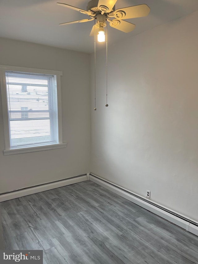empty room featuring wood finished floors and a ceiling fan