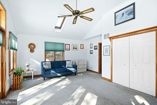 unfurnished room with carpet, ceiling fan, and lofted ceiling with skylight