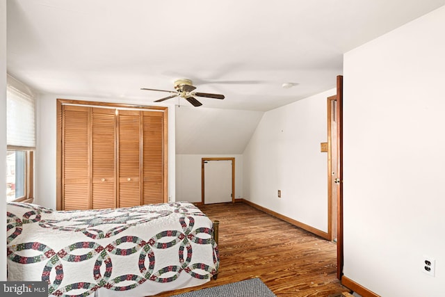 bedroom with vaulted ceiling, ceiling fan, a closet, and hardwood / wood-style floors